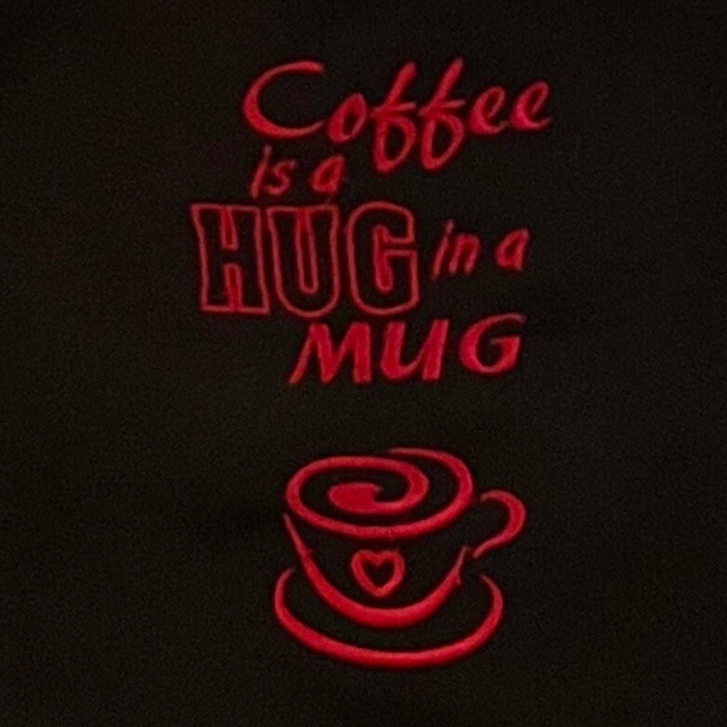 Detailansicht der Stickerei: Coffee is a hug in a mug